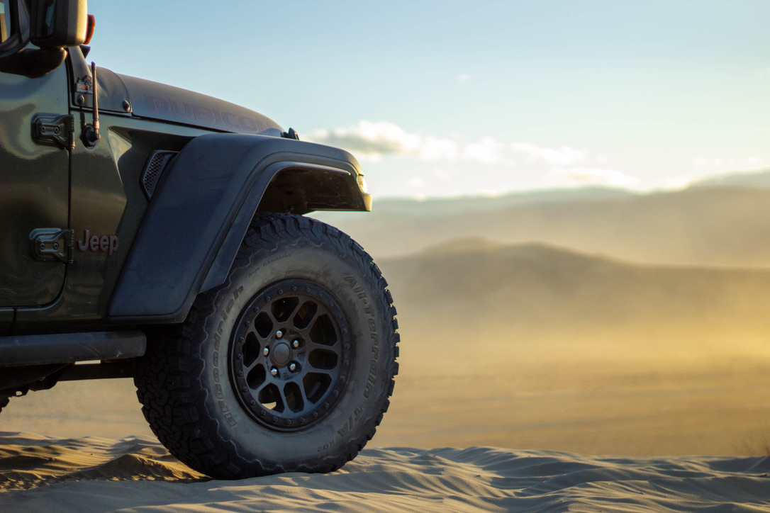 Image of a Jeep Wrangler BFG Tire with a view behind it